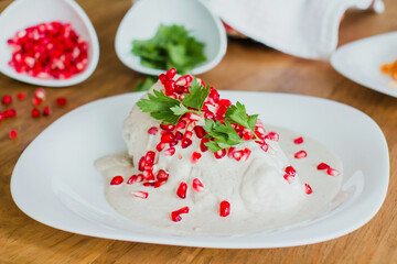 chiles en nogada, traditional Mexican dish with poblano chili peppers and walnut sauce from Puebla Mexico
