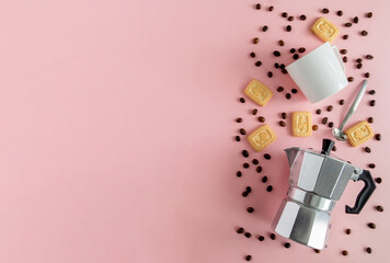 On pink background aluminum geyser coffee maker, white cup, coffee beans and cookies. Horizontal orientation, selective focus. Copy space, view from above