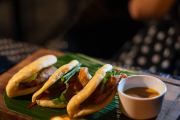 Traditional indonesian food served in a taco bread with stuffed fill in chicken and sauce during dinner