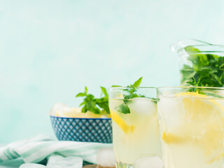 Fresh lemon lemonade in jug and glasses