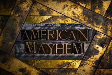 American Mayhem text formed with real authentic typeset letters on vintage textured silver grunge...