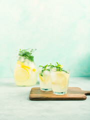 Fresh lemon lemonade in jug and glasses