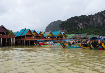 Koh Panyi, Thailand. August 08, 2018. The village of the sea Gipsies. The pier with a several touristic painted boats.