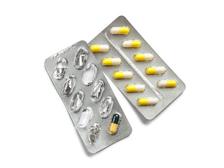 Foil blister packs with gelatin capsules on a white background