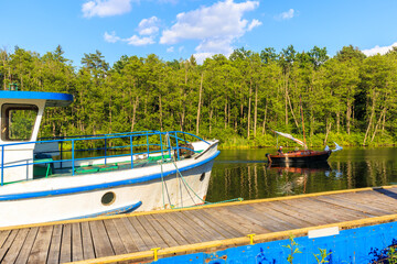 Fototapeta na wymiar LAKE BELDANY, POLAND - JUN 28, 2020: Sailing boat on Lake Beldany near Ruciane Nida, Masurian Lakes, Poland. This region is popular holiday destination for people of Warsaw city.