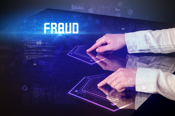 Hand touching digital table with FRAUD inscription, new age security concept
