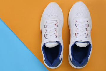 Sports shoes on a colorful background. View from above. Place for text. Flat lay