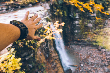 first person view man hands showing waterfall