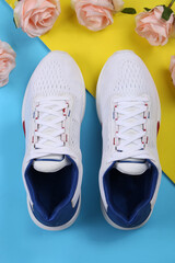 Sports shoes on a colorful background. View from above. Place for text. Flat lay