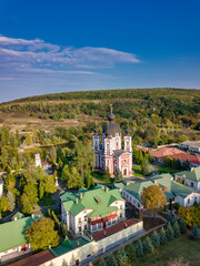 Flight over a christian monastery surrounded by autumn forest. Kurky monastery, Moldova republic of. © Igor Syrbu