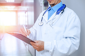 young doctor with stethoscope in hospital hall