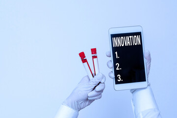 Handwriting text writing Innovation. Conceptual photo the application of better solutions that meet new requirements Extracted blood sample vial with lastest technology ready for examination - obrazy, fototapety, plakaty
