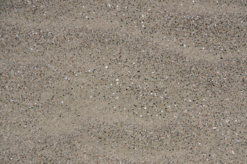 High angle full frame view of the glittery wet sand on the Santa Barbara beach on a summer day