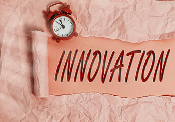 Word writing text Innovation. Business photo showcasing the application of better solutions that meet new requirements Rolled ripped torn cardboard placed above a wooden classic table backdrop - obrazy, fototapety, plakaty