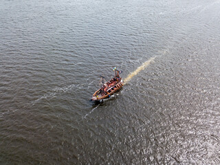 Aerial drone view. A pirate motor boat sails along the Dnieper River in Kiev.