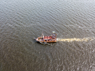 Aerial drone view. A pirate motor boat sails along the Dnieper River in Kiev.