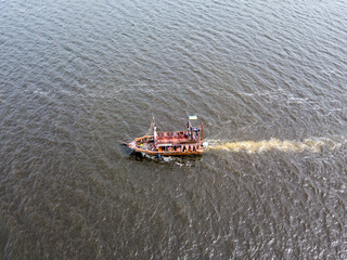 Aerial drone view. A pirate motor boat sails along the Dnieper River in Kiev.