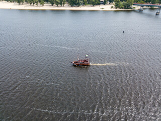 Aerial drone view. A pirate motor boat sails along the Dnieper River in Kiev.