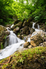 Fototapeta na wymiar Waterfall in Cherek gorge in the Caucasus mountains in Russia