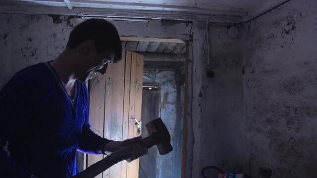 A madman with a hammer in the old building, laughing. copy space