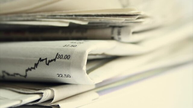 Pile Of Newspapers. A Stack Of Finance Papers.