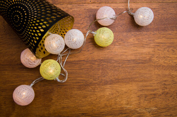 christmas balls and candlestick lie on brown background.