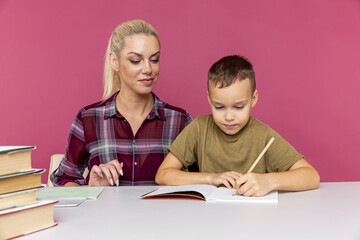 Mother helps her son to study at home. School closed because of quarantine