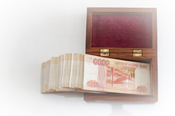 Russian banknotes of five thousand rubles in large quantities in a wooden box