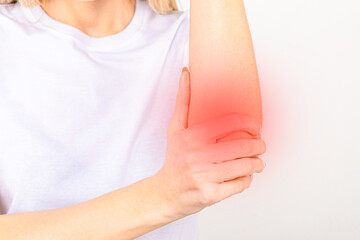 Woman suffering from chronic joint rheumatism. Elbow pain and treatment concept