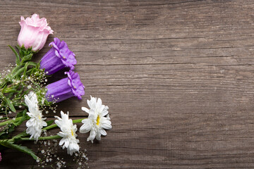 Wild flowers bouquet on wooden background