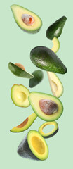 Fresh ripe avocados falling on light blue background