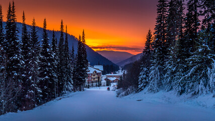 Red Sky as the Sun sets behind the village of Sun Peaks Resort in the Shuswap Highlands, British...