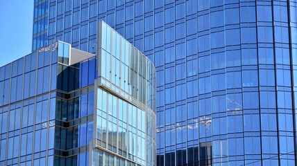 Facade texture of a glass mirrored office building. Fragment of the facade. Modern architecture of the office building.