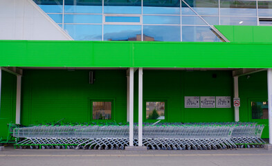 parking for shopping baskets. shopping in the supermarket. parked baskets. empty parking lot....
