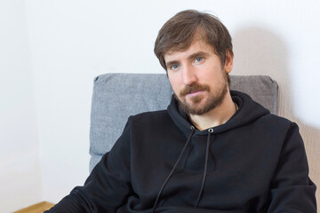 Portrait of a man in the office of a psychotherapist at therapy. Psychology, psychotherapy, social problems, addiction concept.