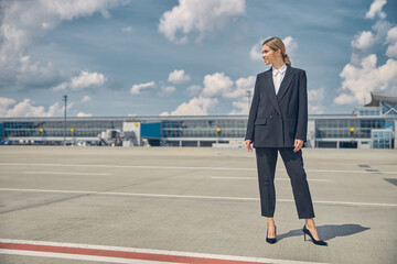 Smiling slender Caucasian pretty lady looking away