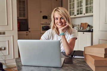 Contented young woman smiling at the table