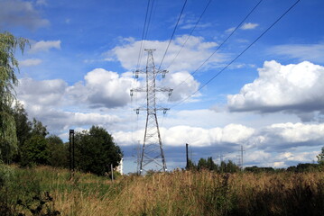 power line pole against a blue sky with clouds