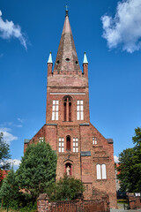Fototapeta na wymiar The tower of the historic, Gothic red brick church in the city of Skwierzyna