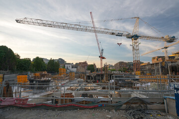 Fototapeta na wymiar Panoramic View of Urban Construction Site with cranes and building material