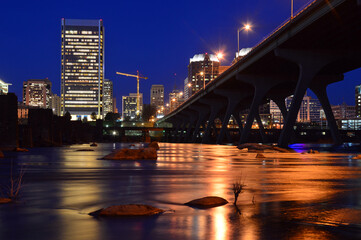 Fototapeta na wymiar The lights of Richmond Virginia reflect in the James River