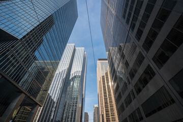 Fototapeta na wymiar Lookup view of dense skyscrapers in a metropolitan area