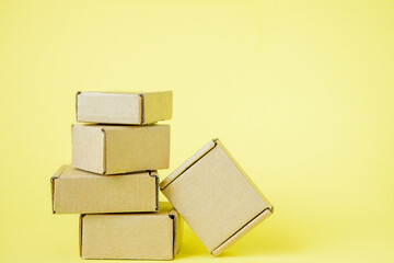 Cardboard boxes of various sizes on yellow background.