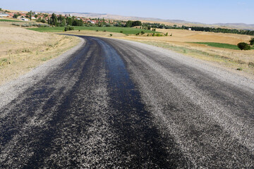 bitumen on the asphalt road, which melts due to the heat in the summer, melted pitch and asphalt road, hot and melted asphalt roads,