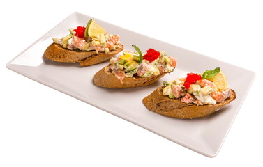 Bruschetta with salmon and avocado. Isolated image on white background.