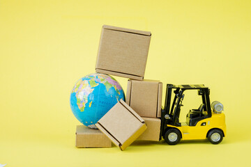Mini forklift truck load cardboard boxes. Fast delivery of goods and products. Logistics, connection to hard-to-reach places. Banner, copy space