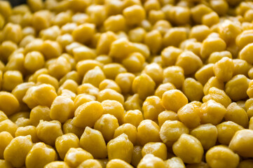 Cooking chickpeas with spices in a pan, close-up