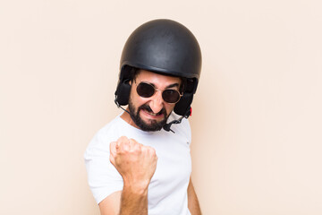 young cool bearded man angry expression with a helmet. motorbike