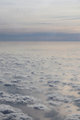 white clouds over the blue ocean, view from the plane window