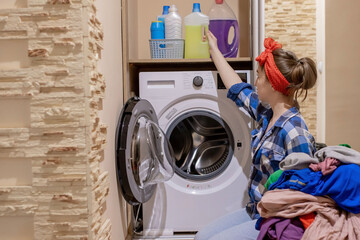 Beautiful young woman doing laundry. Housework